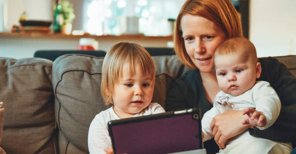 Parent and her children using a tablet